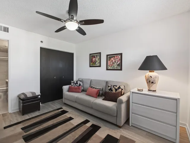 a bathroom with a granite countertop sink a toilet and shower