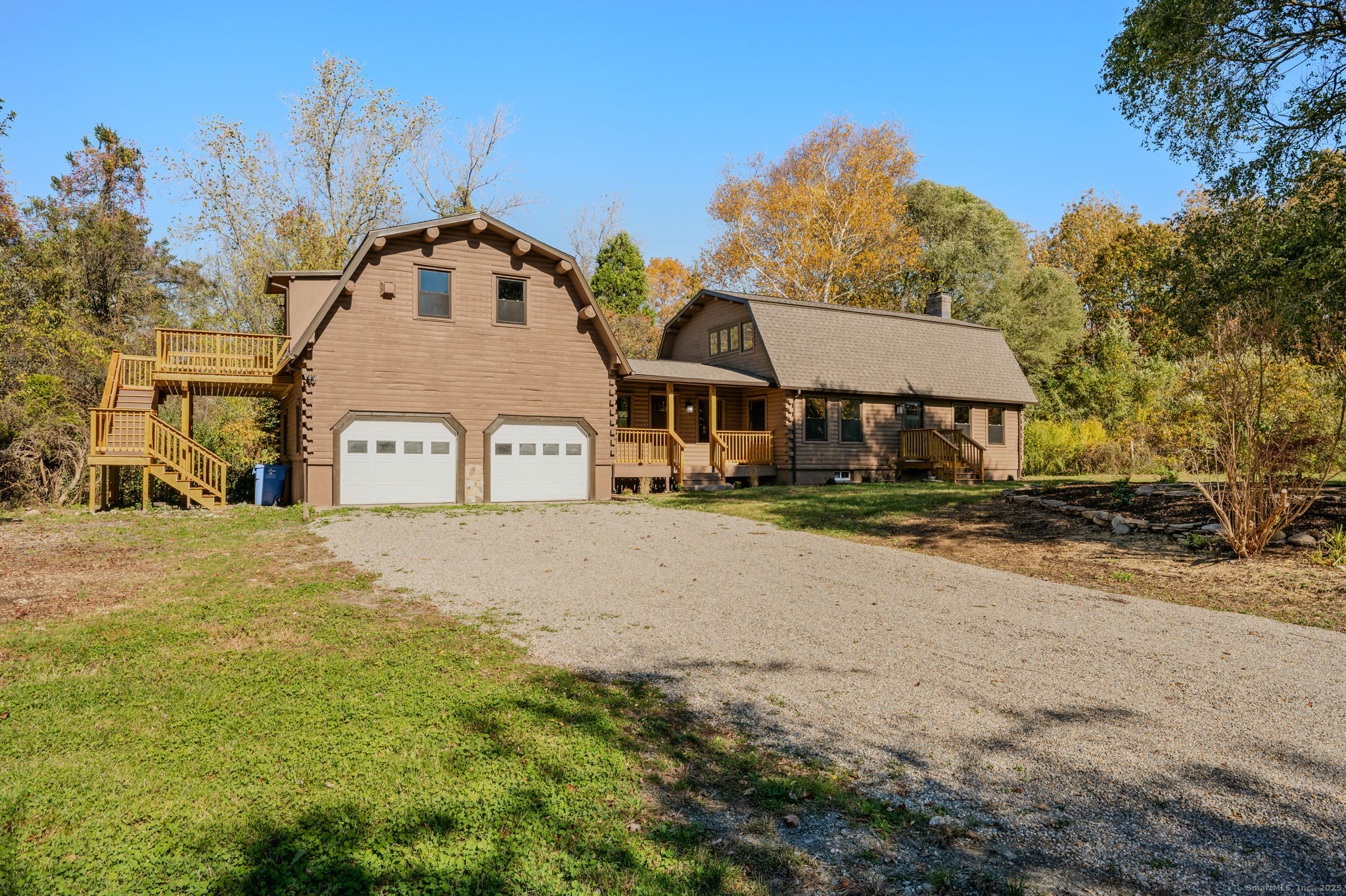 a view of a white house with a yard next to a road