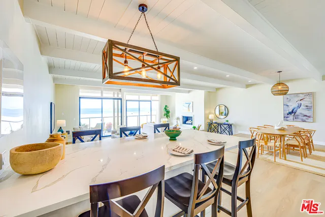 a view of a dining room with furniture and a chandelier