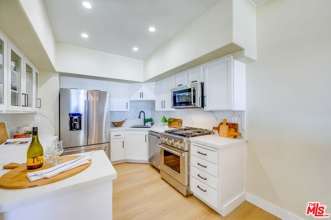 1 Spinnaker Street, Unit 11 Marina del Rey, CA 90292 - Photo 16 of 35 a view of a kitchen with microwave and cabinets