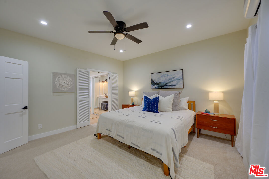 1 Spinnaker Street, Unit 11 Marina del Rey, CA 90292 - Photo 20 of 35 a bedroom with a bed and a chandelier