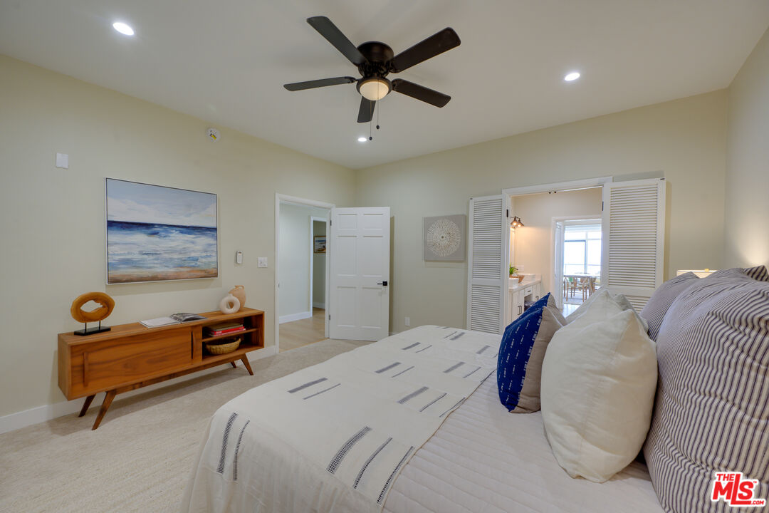 1 Spinnaker Street, Unit 11 Marina del Rey, CA 90292 - Photo 21 of 35 a bedroom with a bed and a chandelier