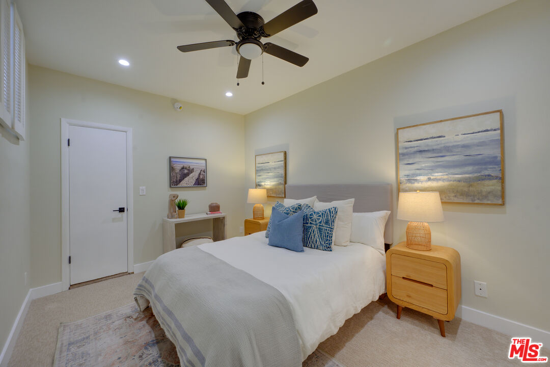 1 Spinnaker Street, Unit 11 Marina del Rey, CA 90292 - Photo 25 of 35 a bedroom with a large bed and a chandelier