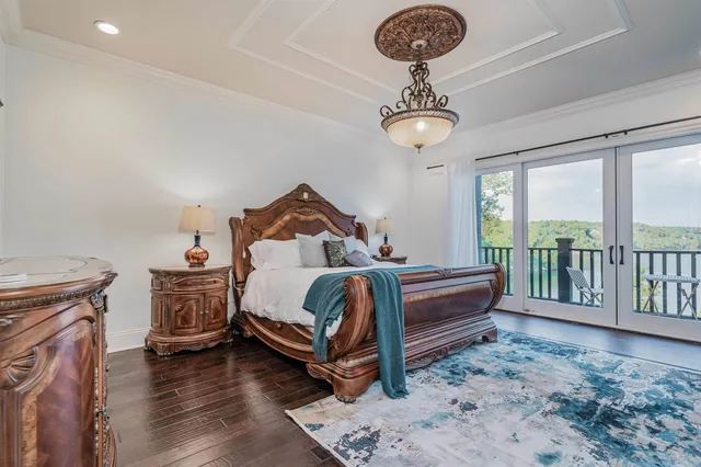 a bedroom with a bed and a chandelier