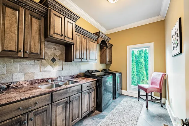 a kitchen with stainless steel appliances granite countertop a stove a sink and a refrigerator