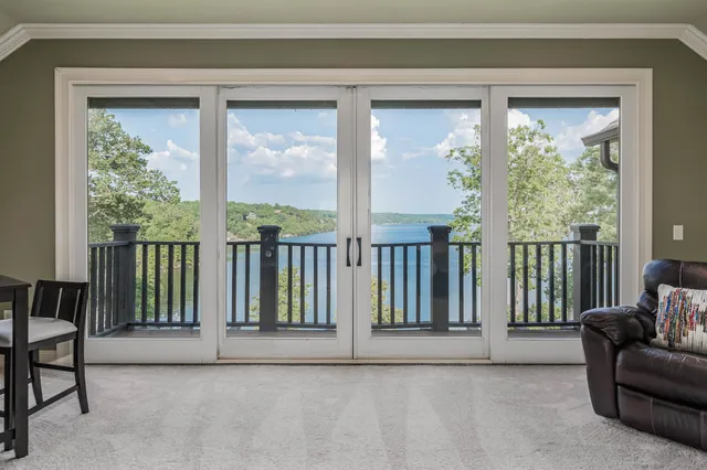 a view of a livingroom with furniture and floor to ceiling window