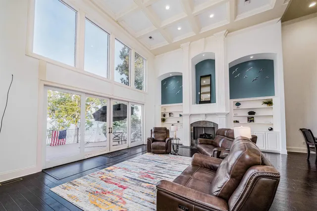 a living room with furniture a fireplace and a flat screen tv