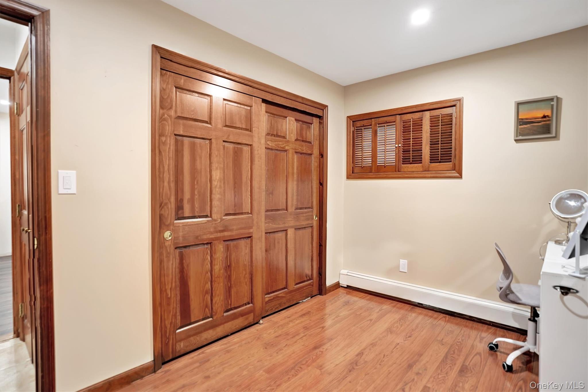 43 Ribbon Lane Wantagh, NY 11793 - Photo 20 of 36 Unfurnished office featuring light wood-type flooring and baseboard heating