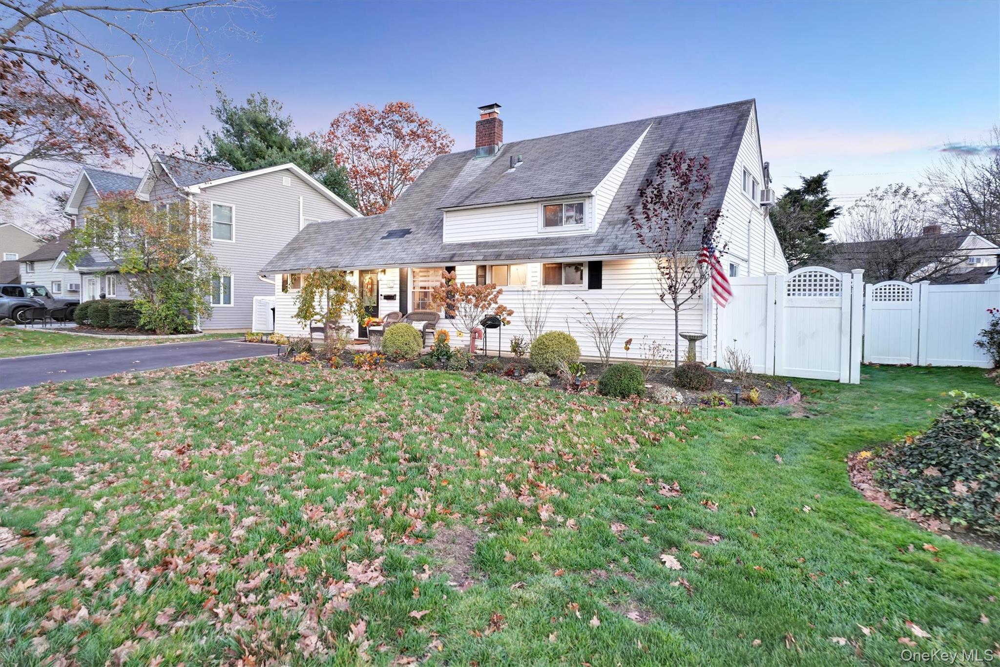 43 Ribbon Lane Wantagh, NY 11793 - Photo 3 of 36 View of front facade with a gate, a chimney, and roof with shingles
