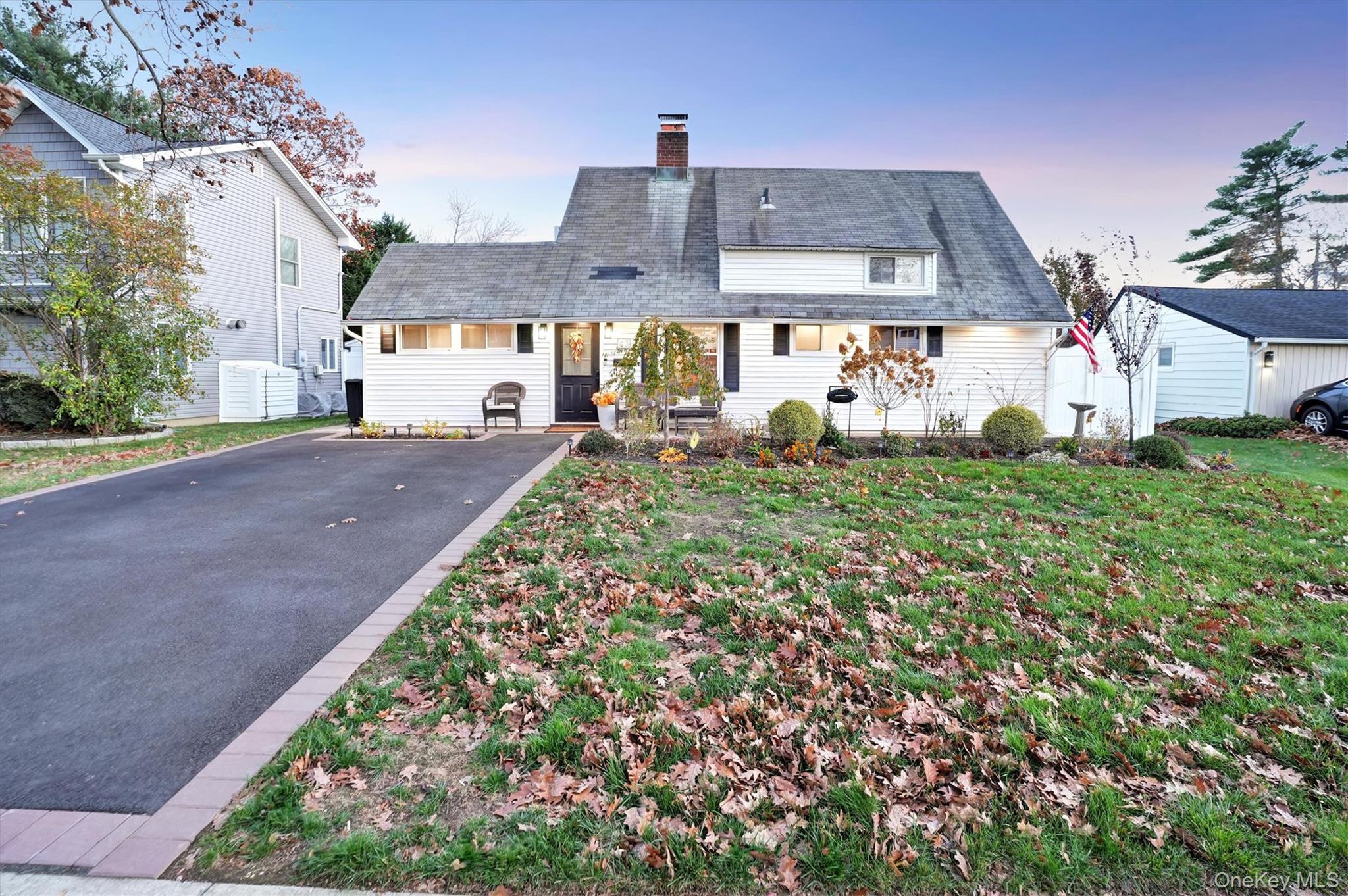 43 Ribbon Lane Wantagh, NY 11793 - Photo 4 of 36 View of front of house featuring a chimney, roof with shingles, and a lawn