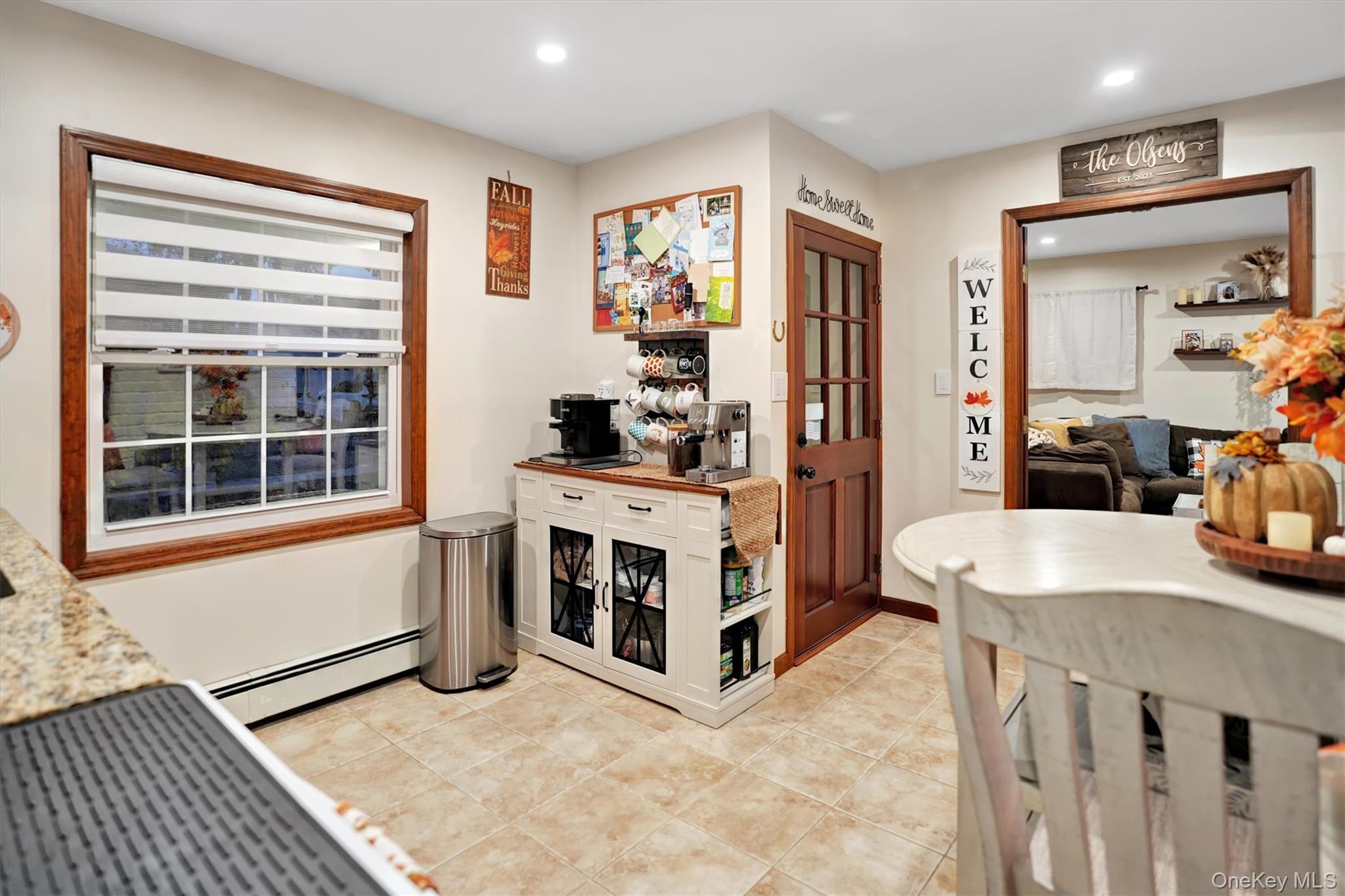 43 Ribbon Lane Wantagh, NY 11793 - Photo 7 of 36 Kitchen featuring a baseboard heating unit, light stone counters, recessed lighting, and light tile patterned flooring