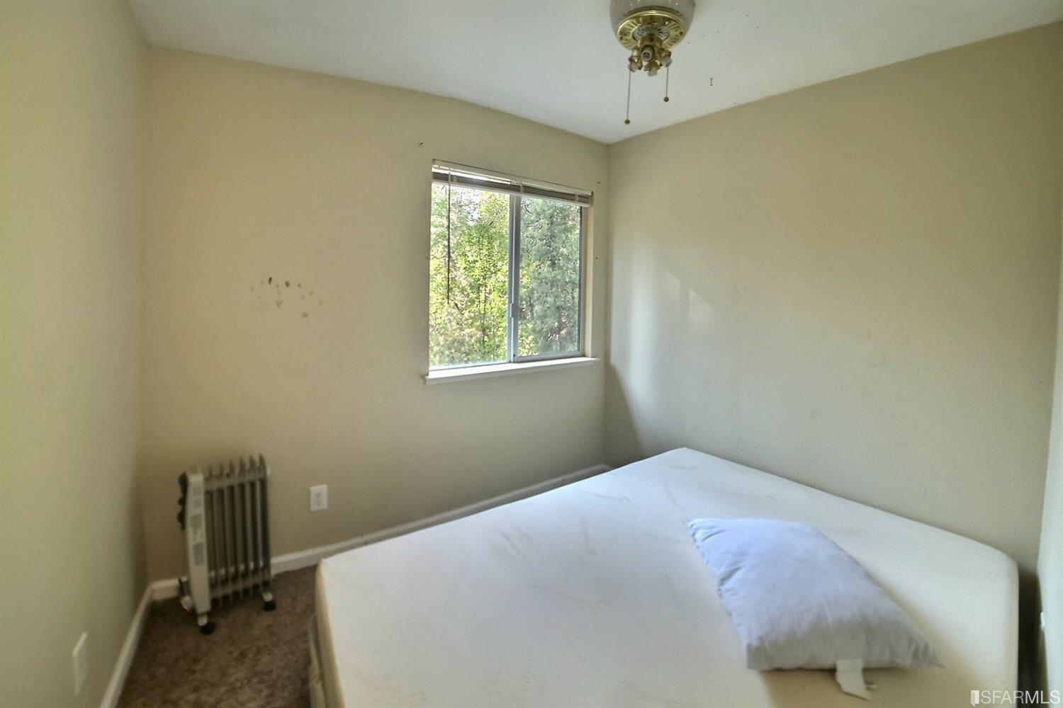241 Ealey Road Glencoe, CA 95232 - Photo 28 of 43 a bedroom with a bed and a chandelier
