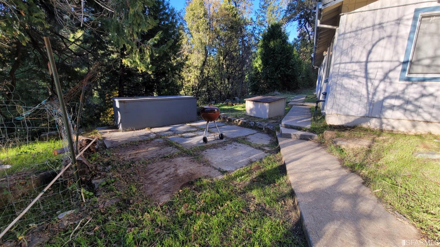 241 Ealey Road Glencoe, CA 95232 - Photo 10 of 43 a view of a patio with table and chairs with wooden fence and plants