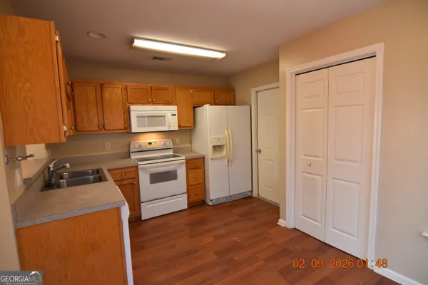 a kitchen with a refrigerator stove and a sink