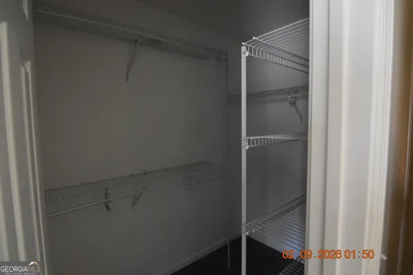 an empty room with a window and a ceiling fan