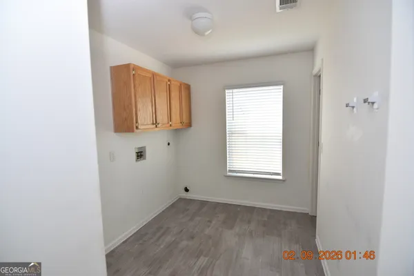 a view of a kitchen with wooden floor and window