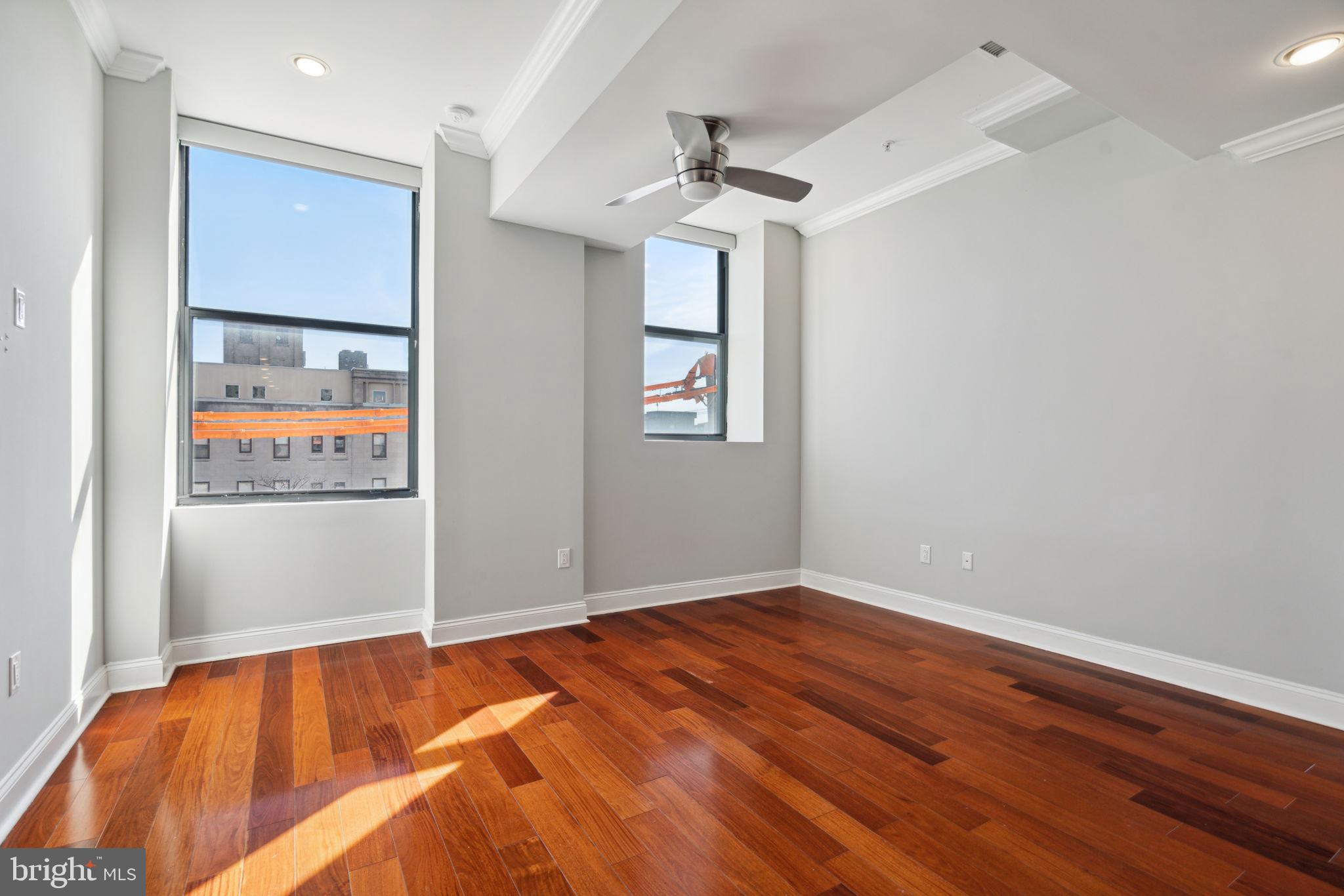 1401-25 North 5th Street, Unit 401 Philadelphia, PA 19122 - Photo 3 of 14 a view of a room with wooden floor and window