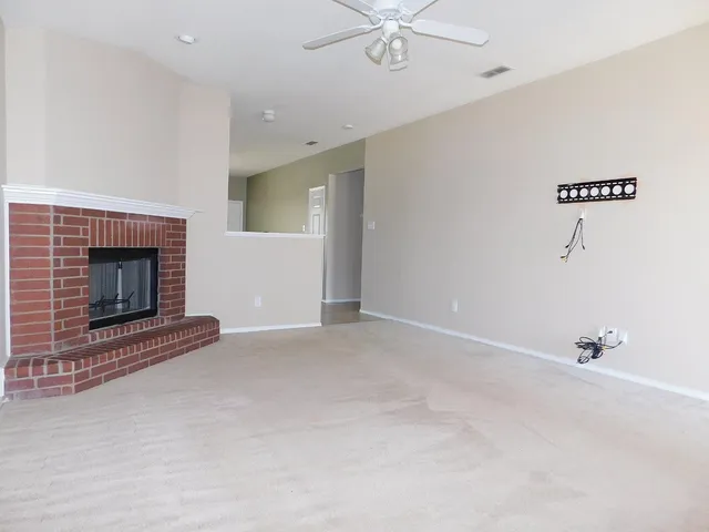 a view of an empty room with a fireplace
