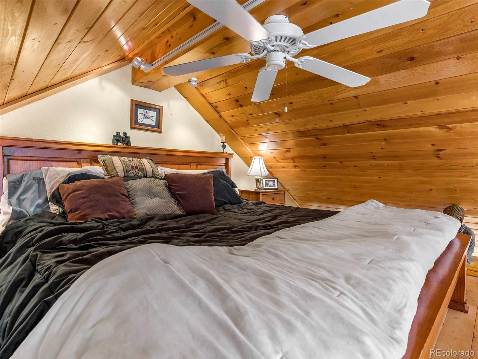 40705 Hill N Dale Road Steamboat Springs, CO 80487 - Photo 11 of 37 a bed sitting in a bedroom next to a window