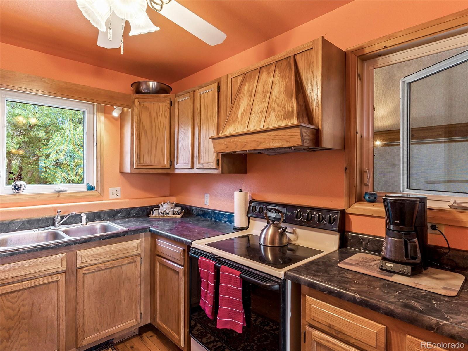 40705 Hill N Dale Road Steamboat Springs, CO 80487 - Photo 19 of 37 a kitchen with stainless steel appliances granite countertop a sink stove and cabinets
