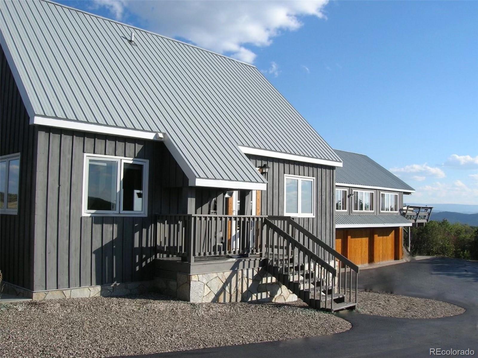 40705 Hill N Dale Road Steamboat Springs, CO 80487 - Photo 2 of 37 a front view of house along with deck and outdoor seating
