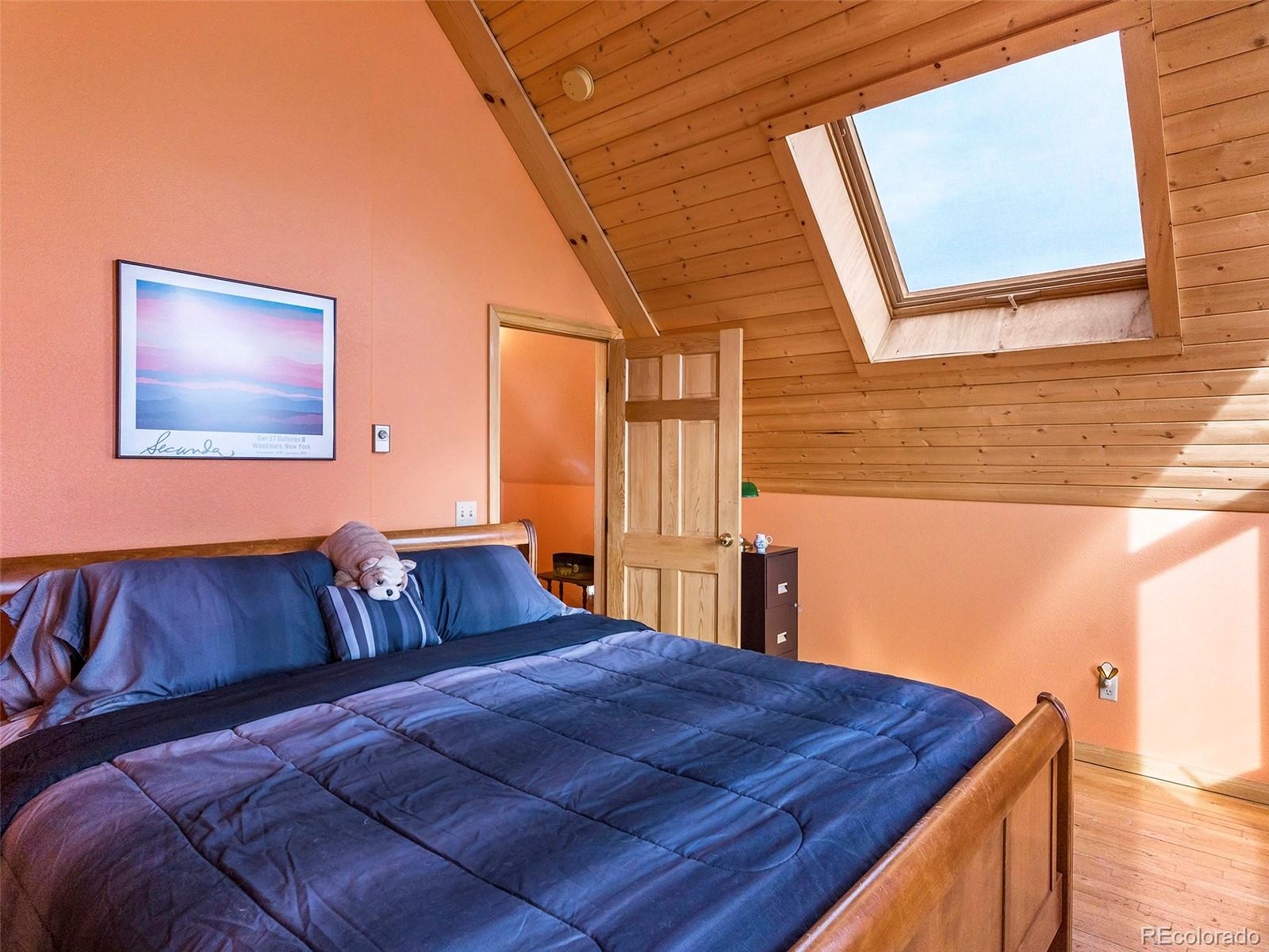 40705 Hill N Dale Road Steamboat Springs, CO 80487 - Photo 25 of 37 a bedroom with a bed and wooden floor