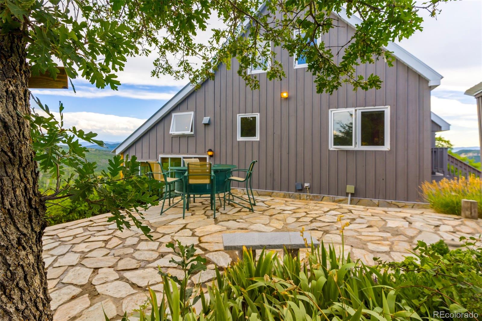 40705 Hill N Dale Road Steamboat Springs, CO 80487 - Photo 34 of 37 a backyard of a house with table and chairs