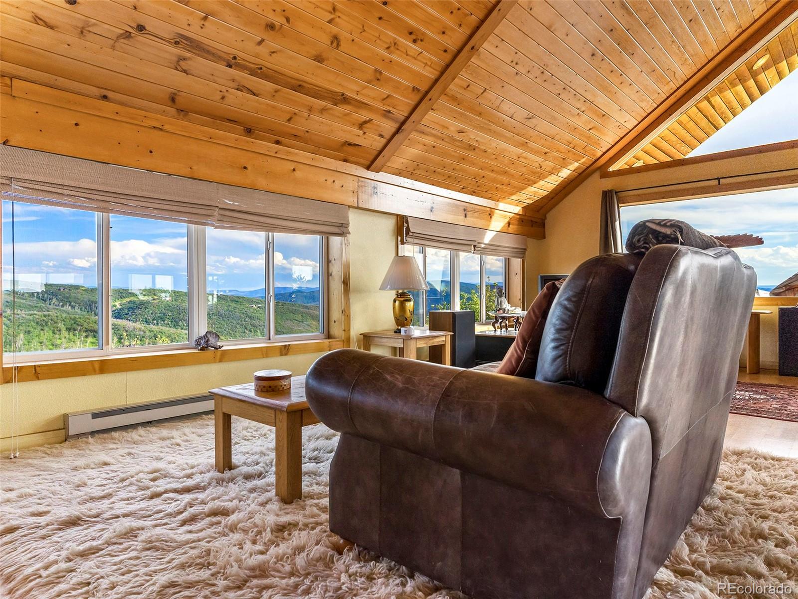 40705 Hill N Dale Road Steamboat Springs, CO 80487 - Photo 6 of 37 a living room with furniture and a floor to ceiling window