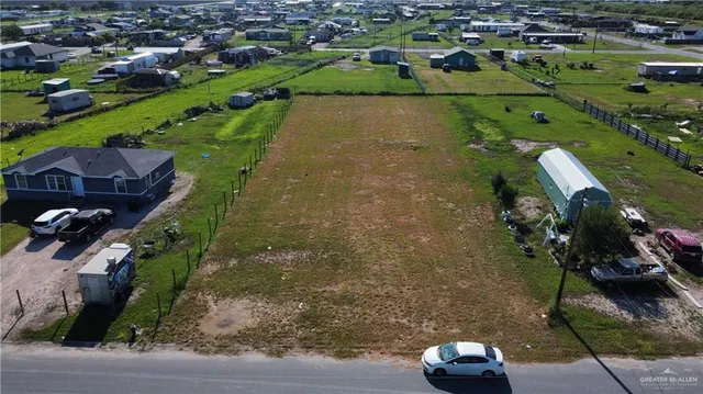 an aerial view of a house with a yard and lake view