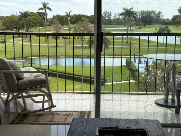 a view of a dining room with furniture and a floor to ceiling window