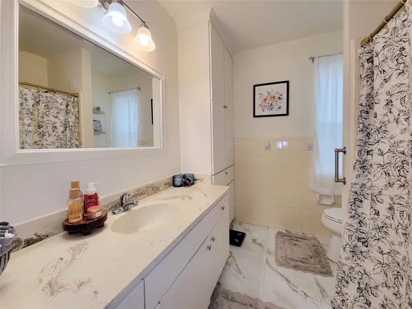 a view of a hallway with wooden floor and entryway