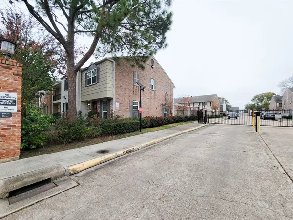 a view of a street with potted plants