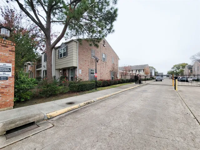 a view of a street with potted plants
