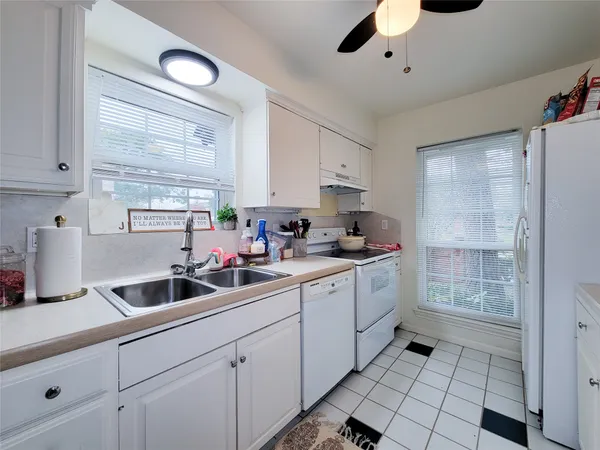 a kitchen with sink cabinets and stainless steel appliances