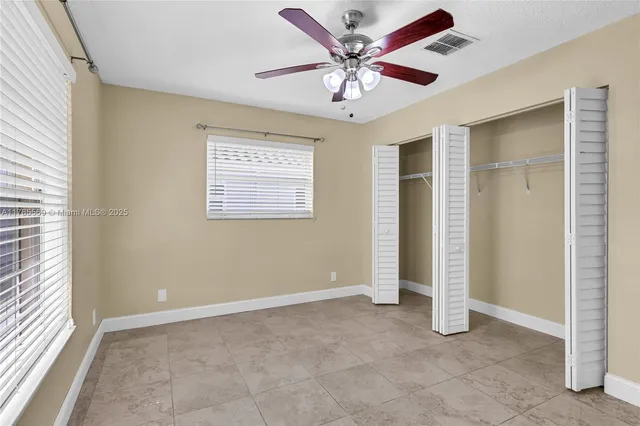 a bath room with a granite countertop sink and a mirror