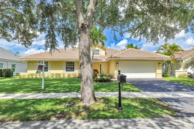 a front view of a house with a yard and porch