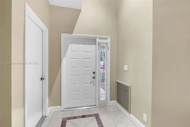 a living room with furniture a flat screen tv and a large window