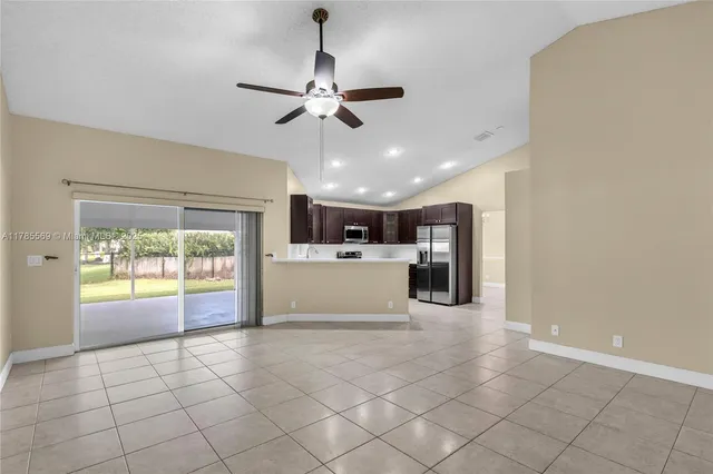 a view of a kitchen with a sink and a ceiling fan