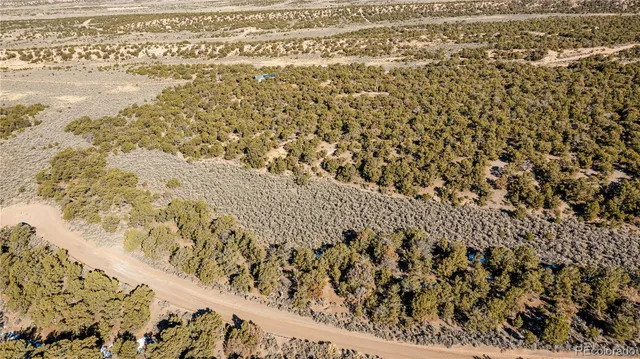 a view of a large building with mountains in the background