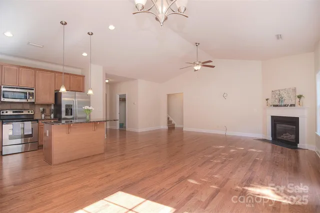 a view of a kitchen with a stove cabinets and wooden floor