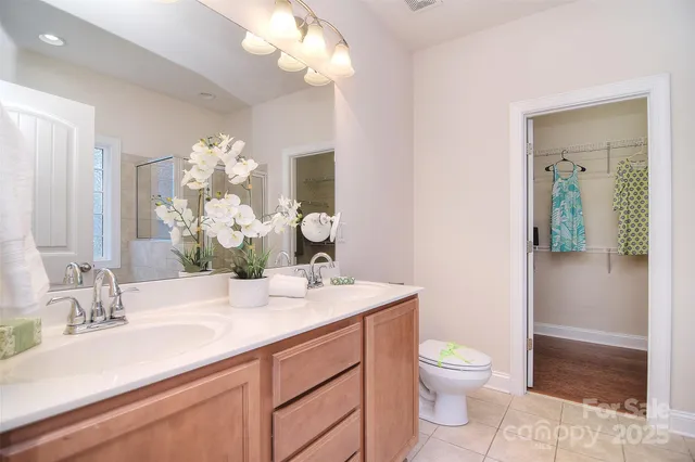 a bathroom with a sink a toilet and a mirror