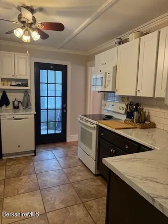 a kitchen with a cabinets and white appliances