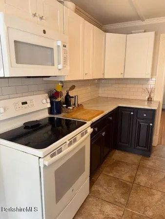 a kitchen with a sink stove and microwave