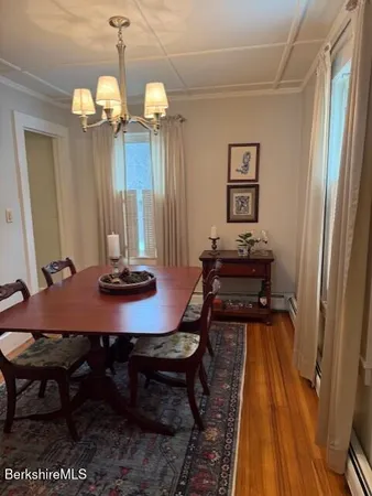 a view of a room with a table and chairs