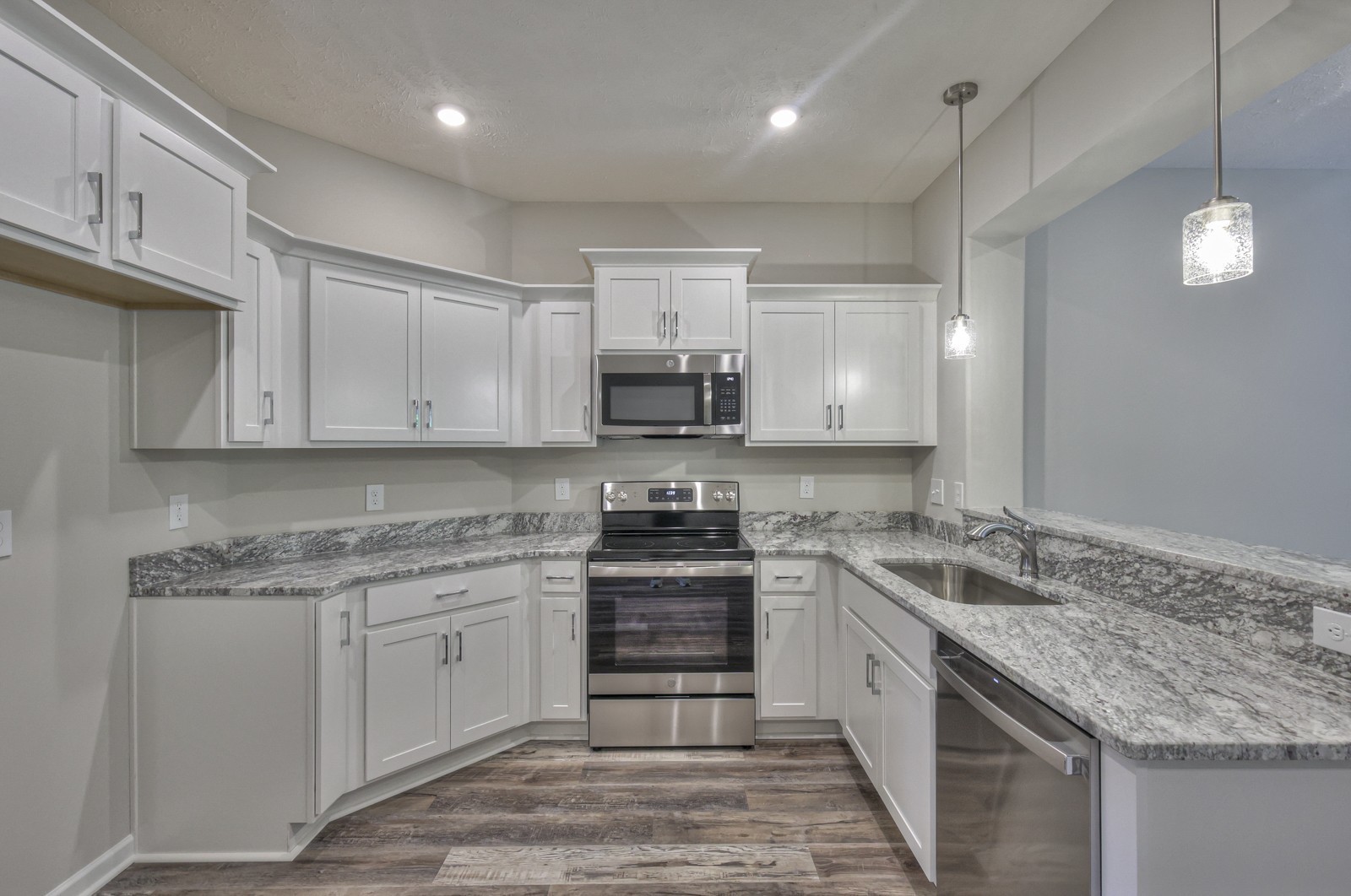 113 Creek Wood Road Manchester, TN 37355 - Photo 13 of 37 a kitchen with granite countertop a sink stainless steel appliances and white cabinets