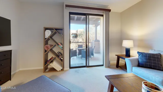 a view of a livingroom with furniture and a window