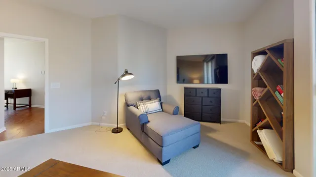 a bedroom with a bed a mirror and a flat screen television