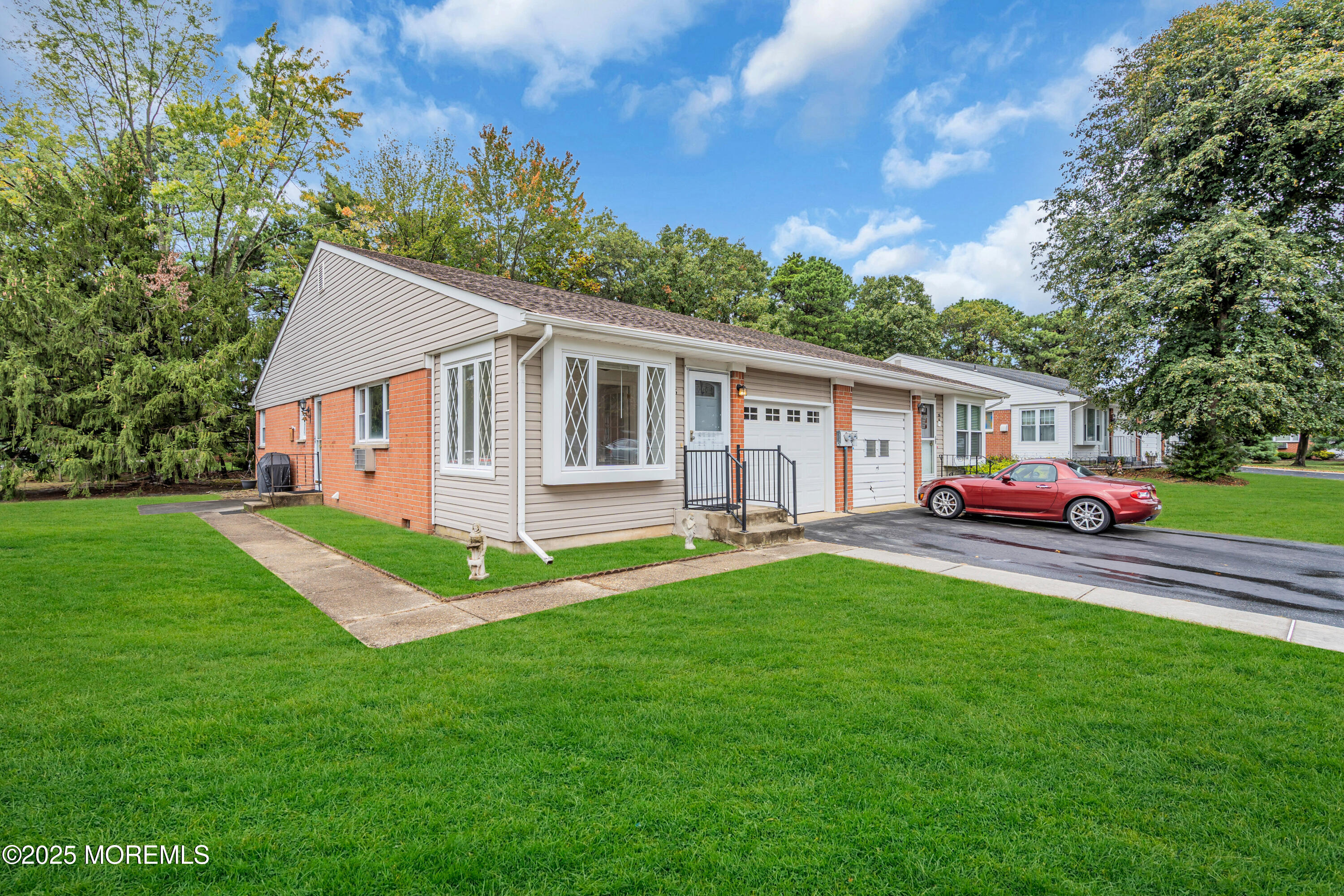 a front view of a house with a garden
