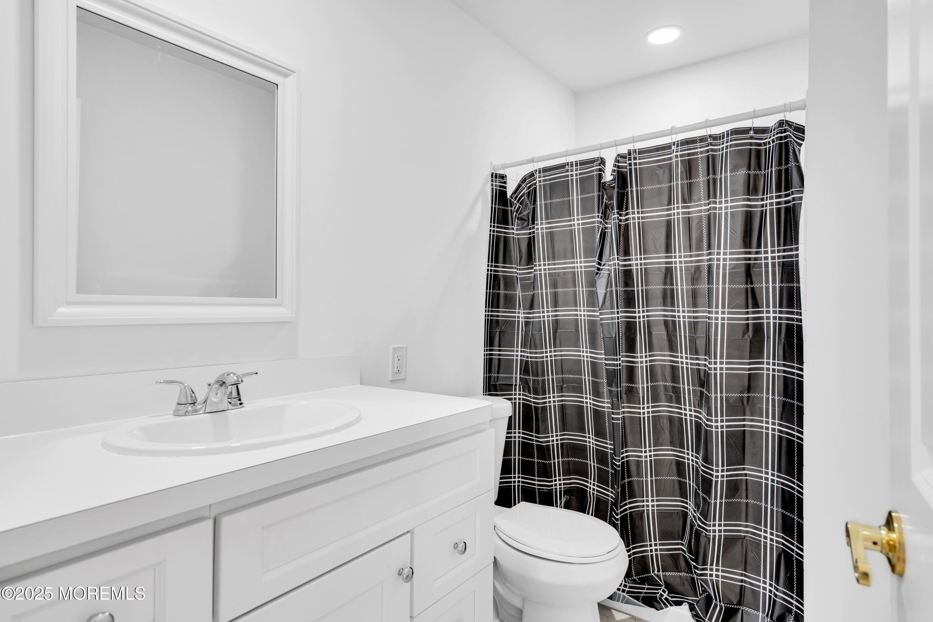26 Columbus Boulevard, Unit A Whiting, NJ 08759 - Photo 11 of 23 a bathroom with a sink a toilet a mirror and shower