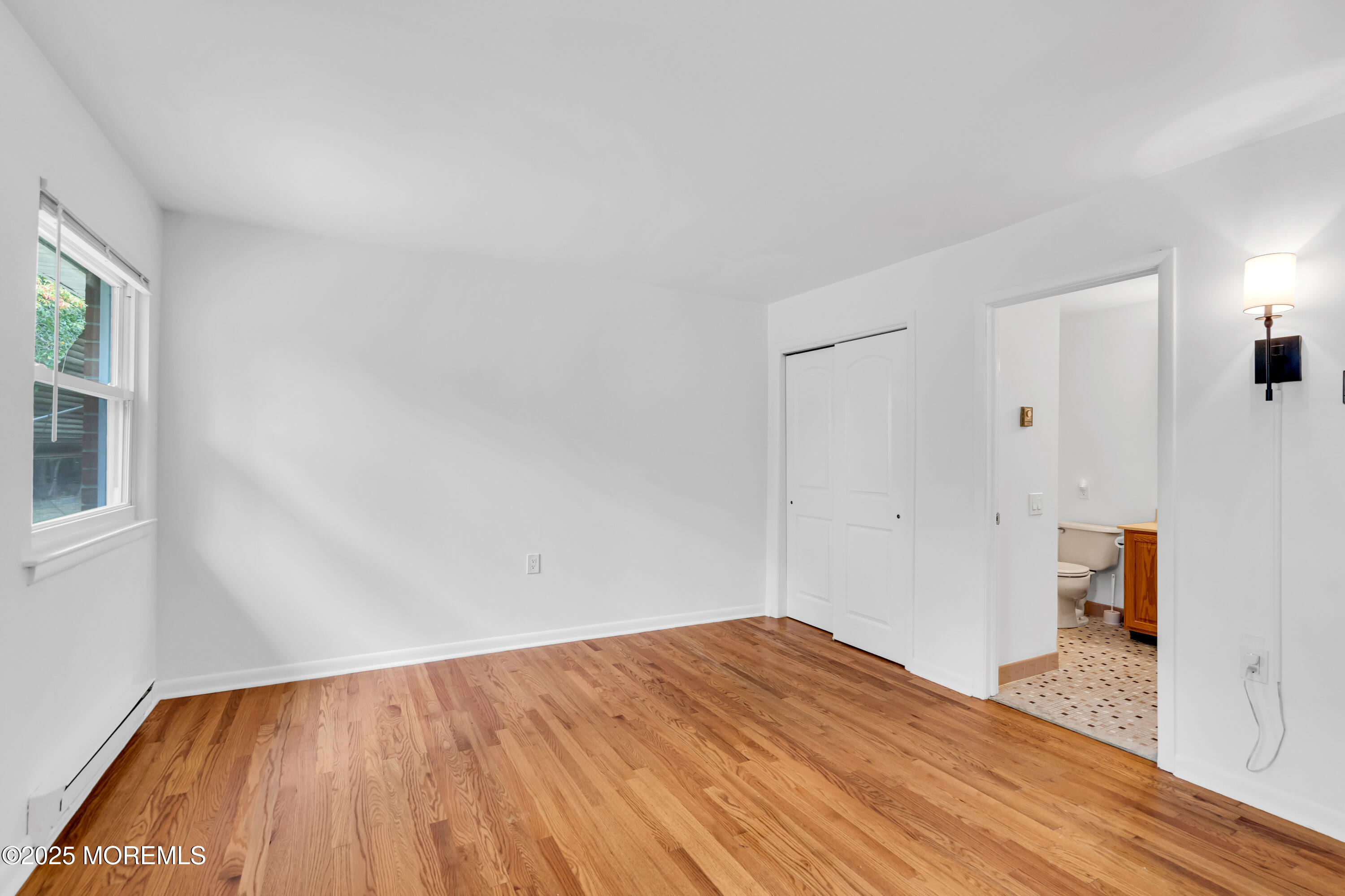 26 Columbus Boulevard, Unit A Whiting, NJ 08759 - Photo 12 of 23 a view of empty room with wooden floor and fan